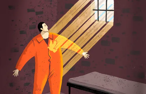 man in prison cell with light shining through window