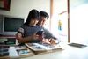 father and daughter looking at photographs