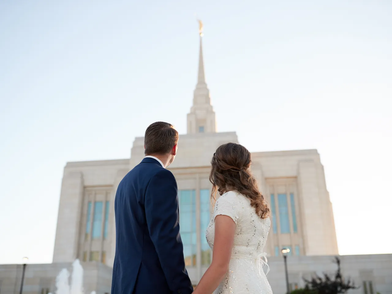 A newly wed couple stand together outside after just being married