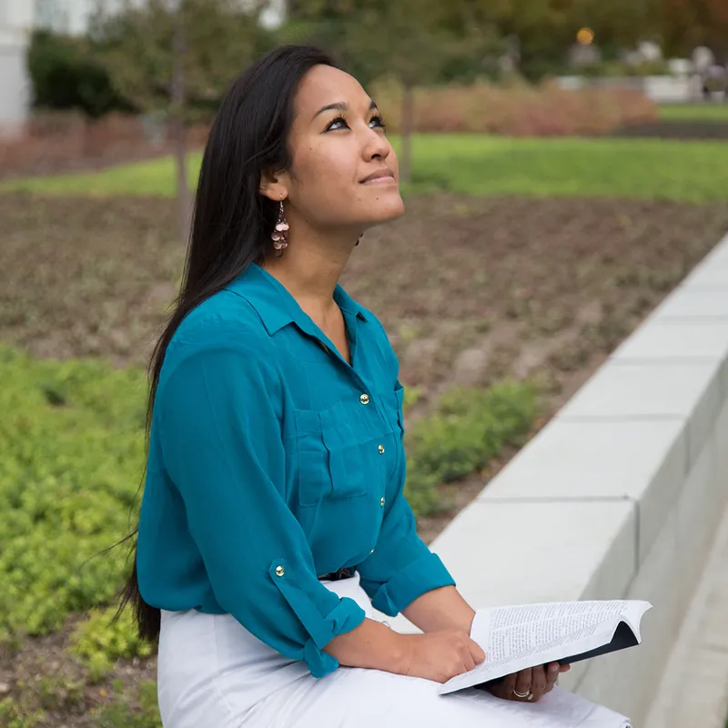 A woman sits on a park bench with the Book of Mormon and learns that babies don't need baptism