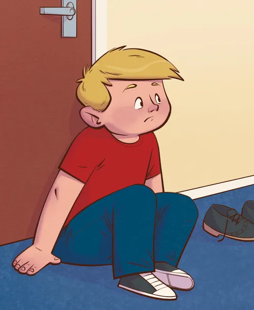 boy sitting in hallway, looking sad