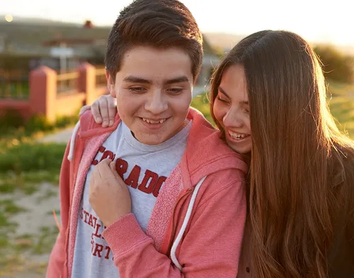 young man and woman hugging