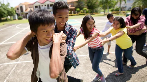 Filipino young men and young women interact during a youth activity.