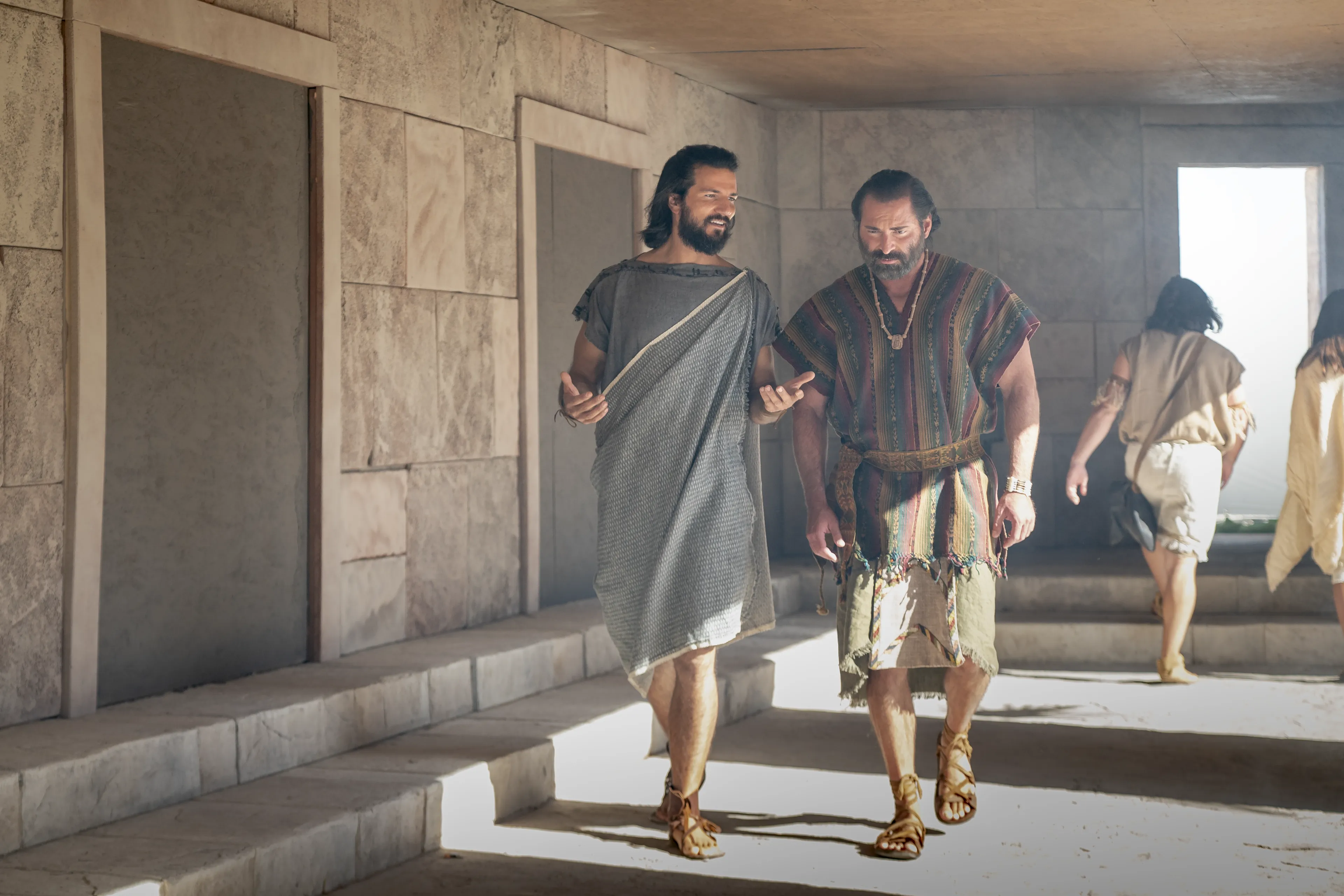 Alma the Younger and Amulek walk and talk together in the city of Ammonihah.