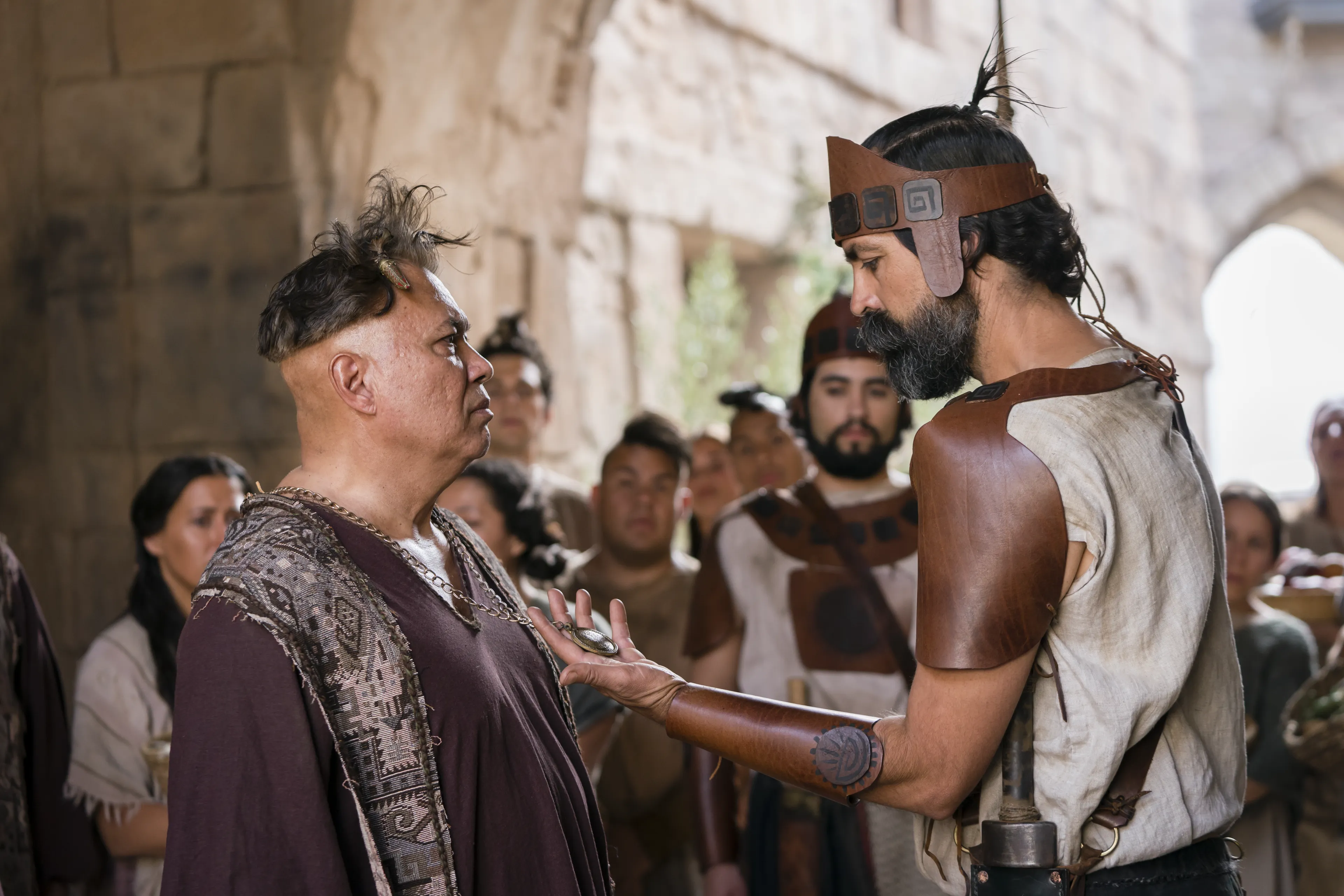 Older priests are stripped of priestly mantles and mocked by members of King Noah’s court.