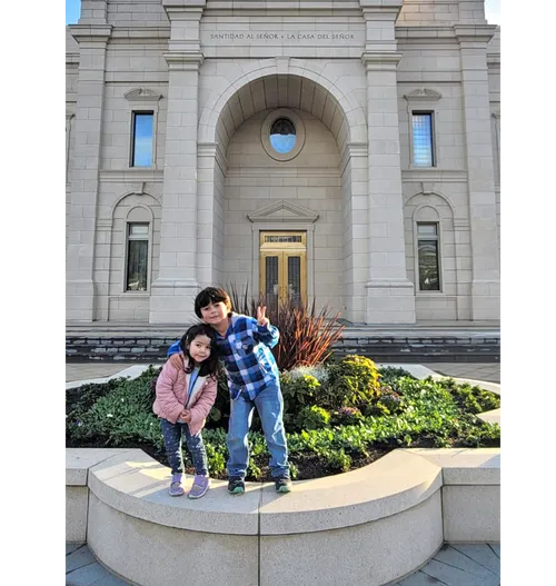 Two children in front of a temple
