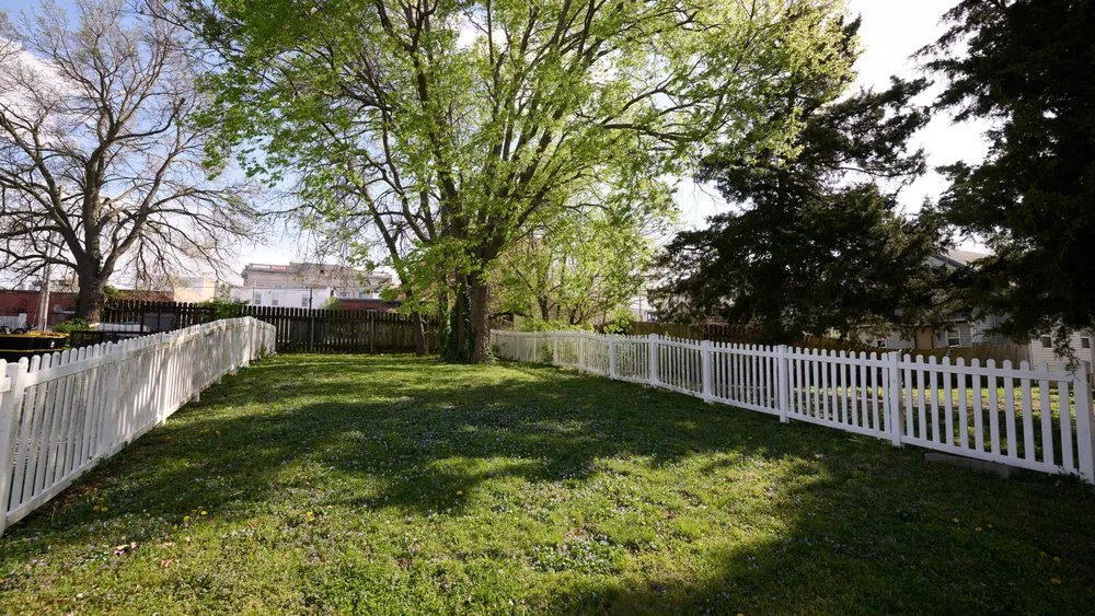 White fence leading into the Richmond Jail Site in Missouri.