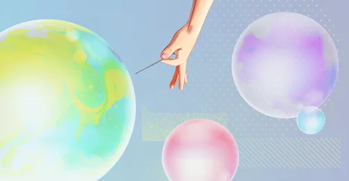 a hand holding a needle about to burst a bubble