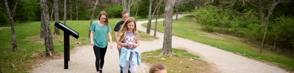 A family walks together around the fields of the Adam-ondi-Ahman Historic site.