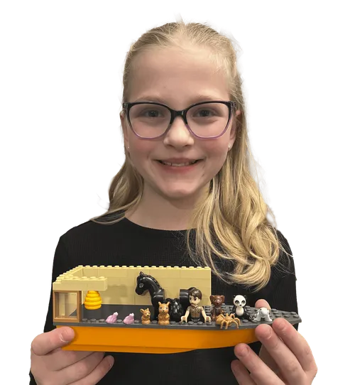 Girl with a plastic-brick model of Noah’s arc