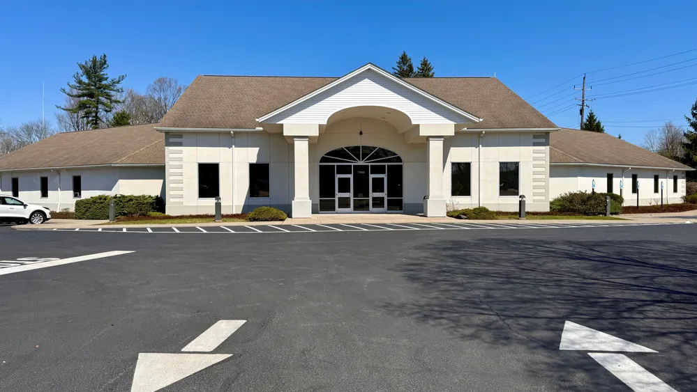 The entrance to a large whitish-gray building.