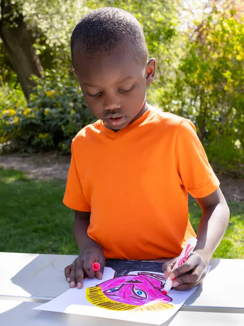 A boy coloring a picture
