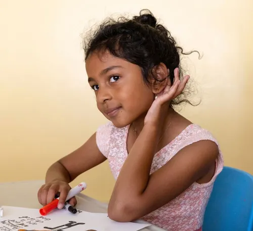 girl with hand cupped around her ear