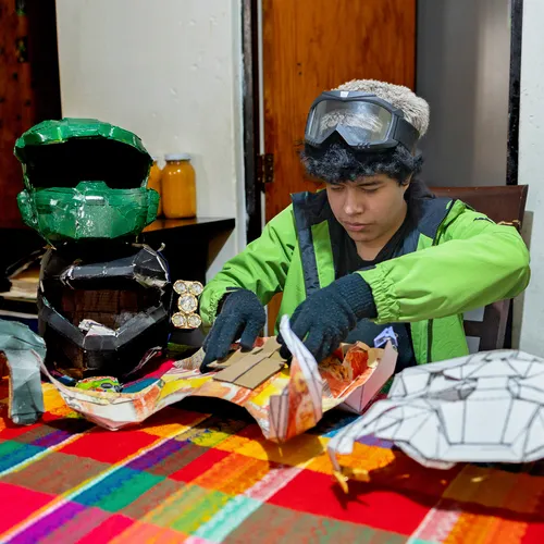 young man working on armor