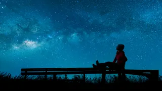 Girl watching the stars in night sky