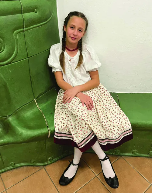 Girl sitting on chair with legs crossed