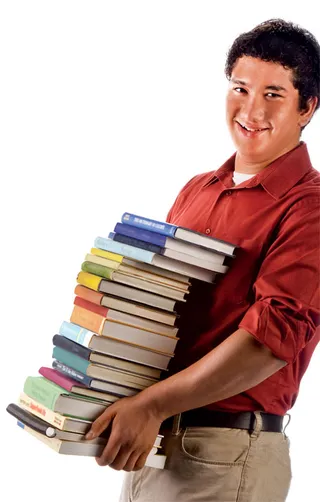 young man carrying stack of books