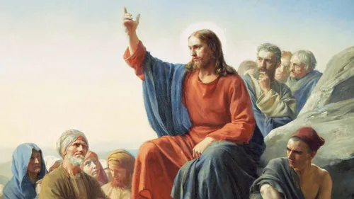 Jesus Christ raising His arm and teaching a group of people