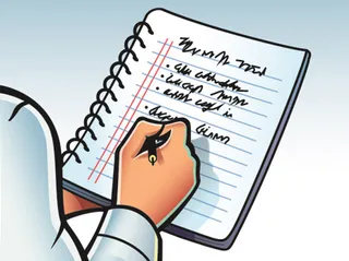 person writing in notebook