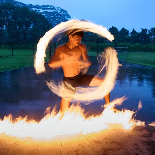 young man twirling a torch