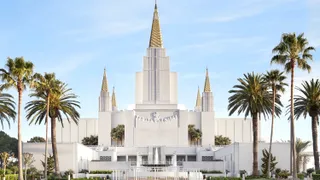 Oakland California Temple Exterior image. This image features the temple and temple grounds. You see trees, the fountain, and the entrance of the temple.