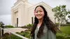 young woman standing outside temple