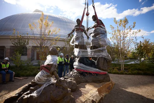 A view of Temple Square while under construction in November 2024. The image features the two parts of the First Vision Statue being put together in the northwest quadrant next to the Salt Lake Tabernacle. Do Not Copy.