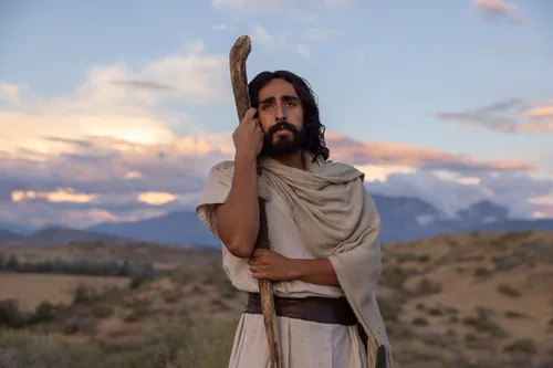 Depiction of Jesus Christ standing in a field leaning against His shepherd staff. Detail from the Easter 2026 campaign.