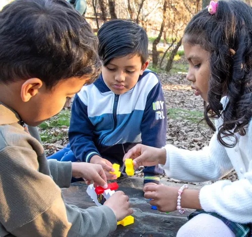 Girl and two boys playing outside