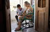 elderly woman and young man looking through photo album