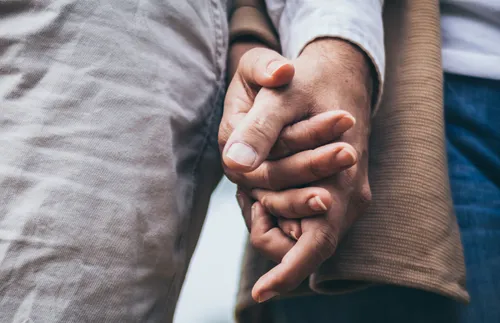 close-up of couple holding hands