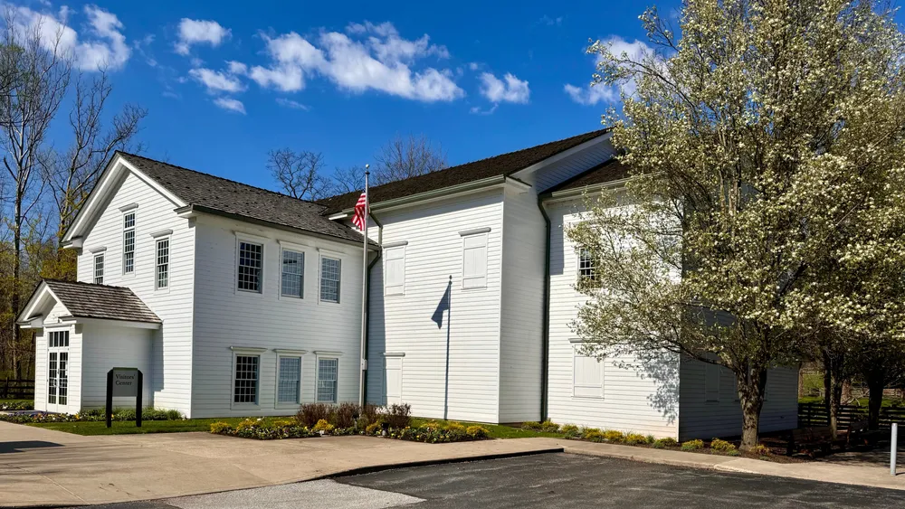A large, white, two-story budling with.
