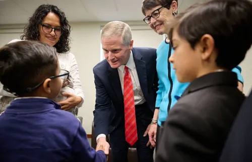 Elder David A. Bednar shaking hands with a boy