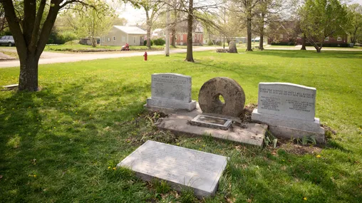A Hawn's Mill Millstone Monument rests on a grassy field in nearby Breckenridge, Missouri