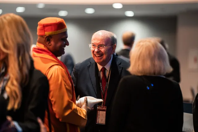 Elder Quentin L. Cook and Sister Mary G. Cook, talk with Guruji His Holiness Dileepkumar Thankappan at the Advance Interfaith Dialogue at New York Forum