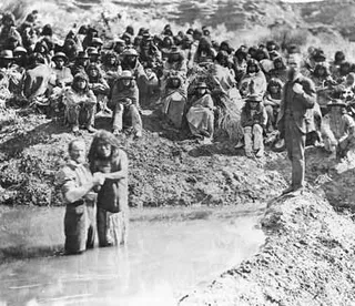 Native Americans being baptized