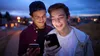 two young men looking at phones