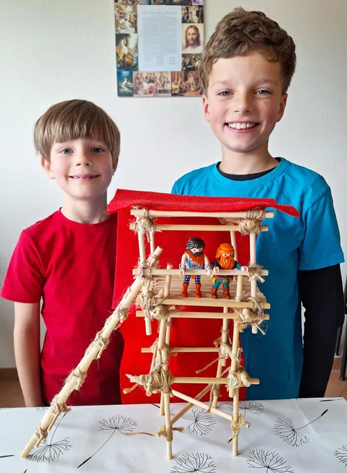 Two boys with a small wooden tower