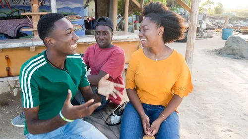 young adults sitting and laughing together