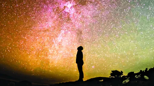 person looking up at a night sky