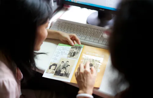 two women studying family history documents