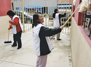 women painting a wall