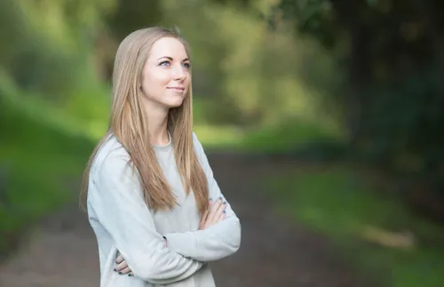 a woman folding her arms and smiling