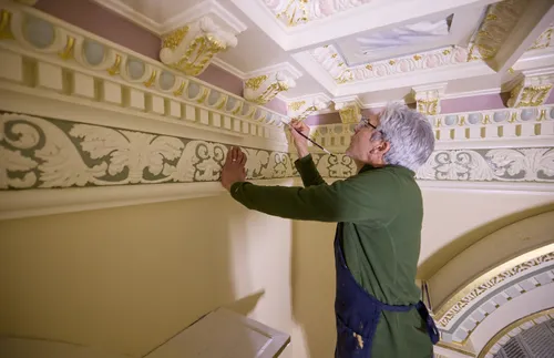 artist working in a temple sealing room