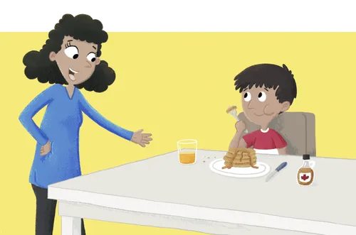 Mom talking to boy, who is sitting at a table and eating pancakes
