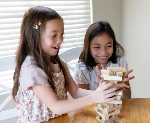 Image of two girls building a tower with blocks