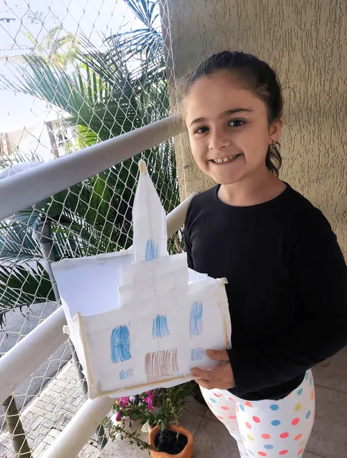Girl holding her paper temple craft