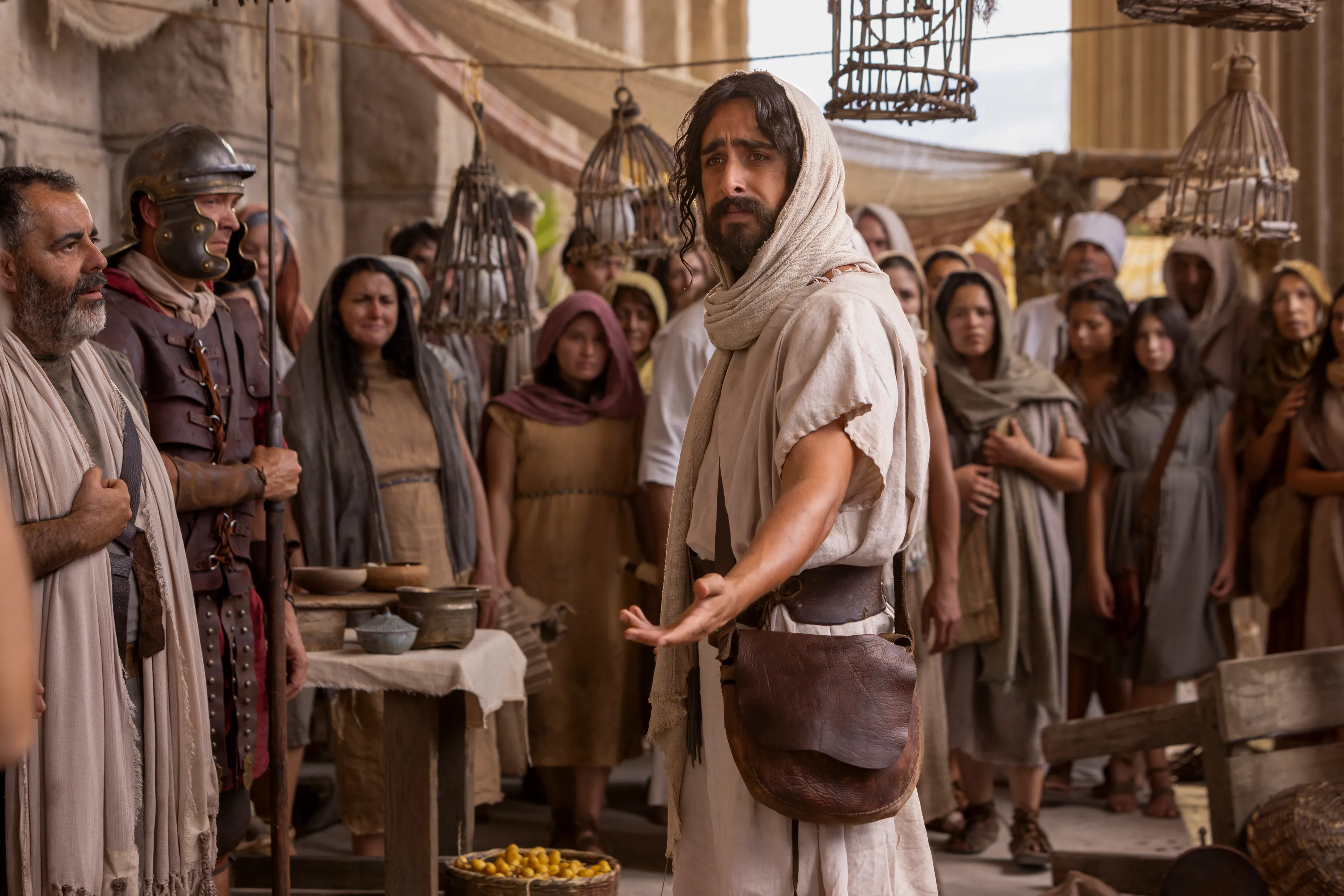 Depiction of Jesus Christ reaching his hand out, while standing in a crowded market place in Jerusalem. Detail from the Easter 2026 campaign. © undefined ipCode 1.