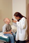 doctor looking at patients throat
