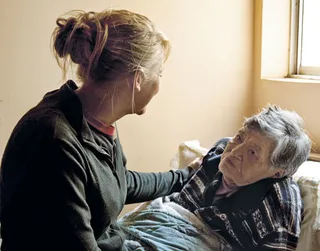 woman helping sick woman